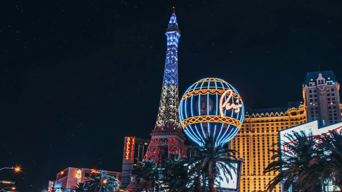 A Las Vegas street at night lined with glowing signs