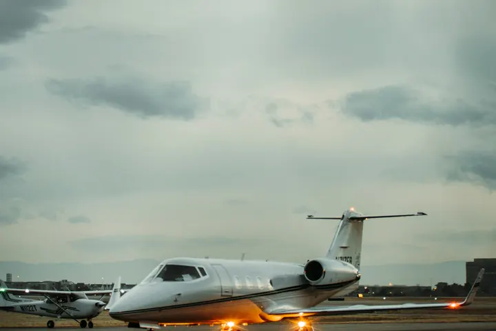A business jet waiting on a darkened ramp