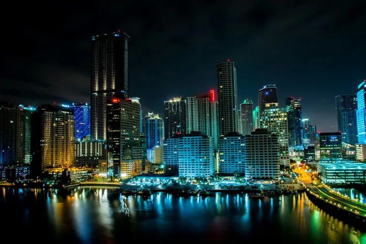 The Miami skyline lit up at night across the water