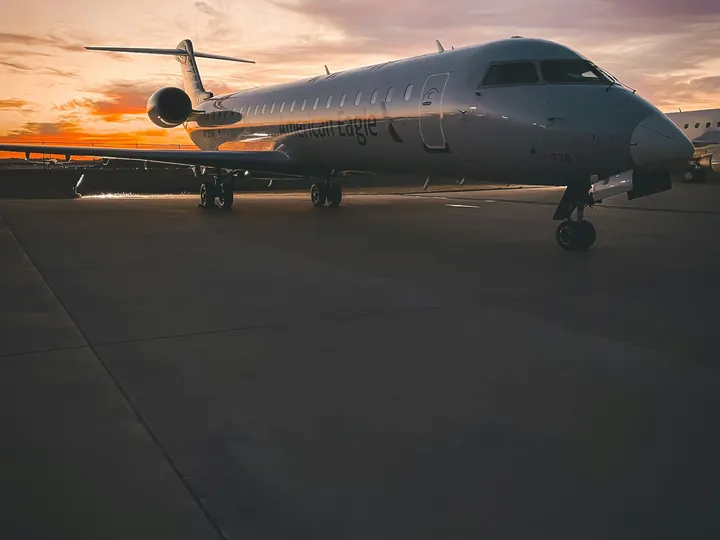 A business jet under a dusky sky on a quiet apron