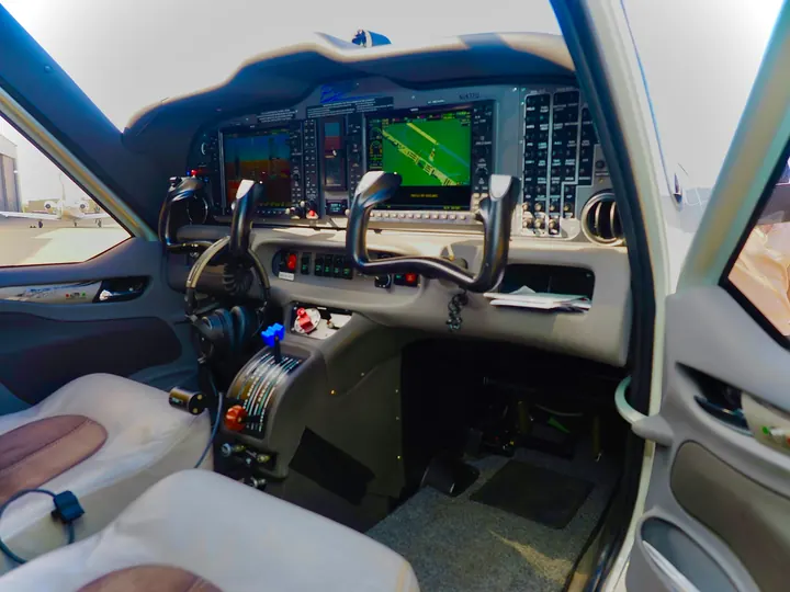 The flight deck of a business aircraft with twin yokes and glass displays
